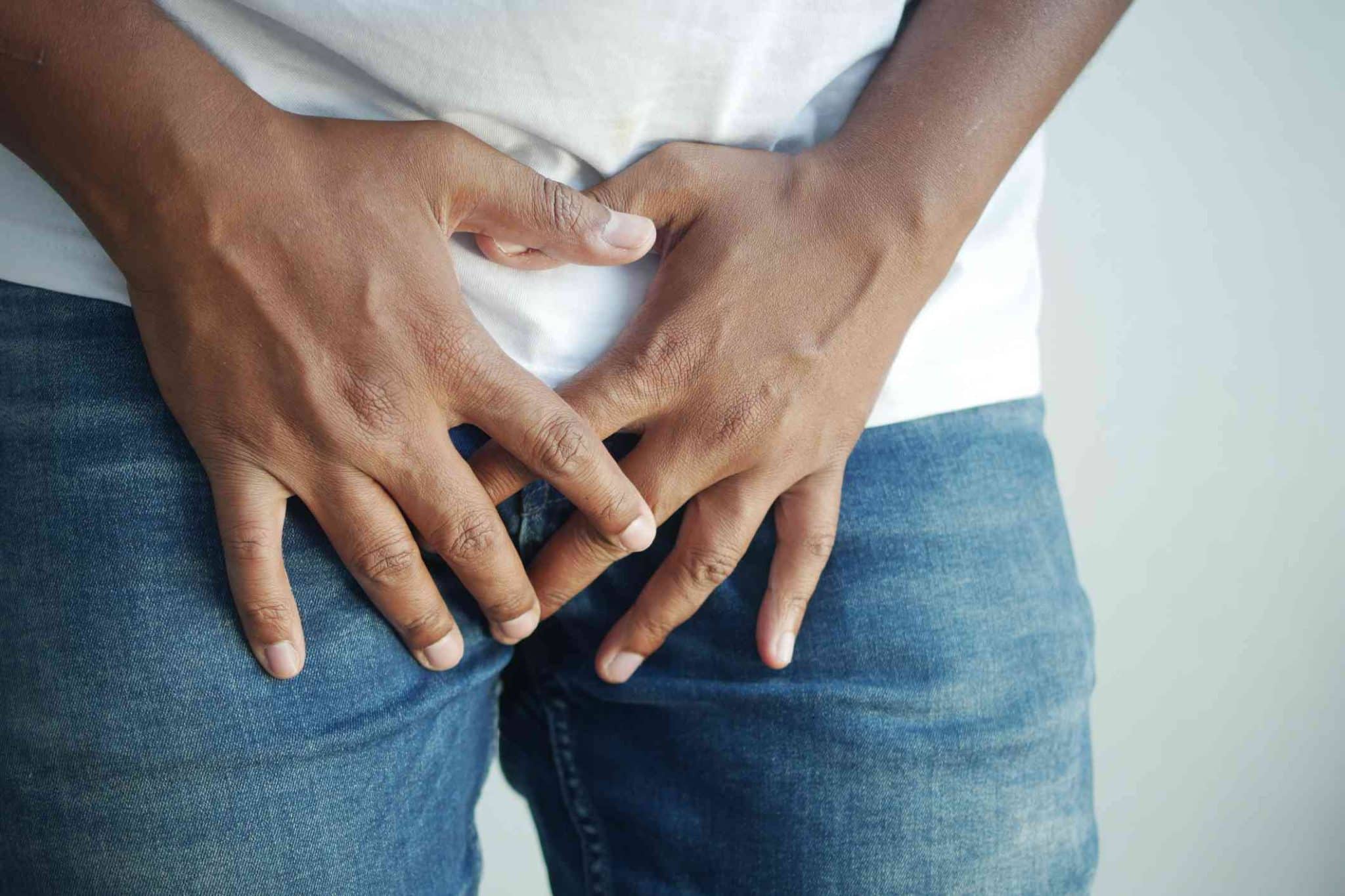 a man holding his privates suffering from genital eczema