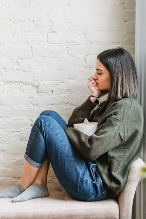 image of a woman looking sad and in need of cheering up with a Halloween gift box treat